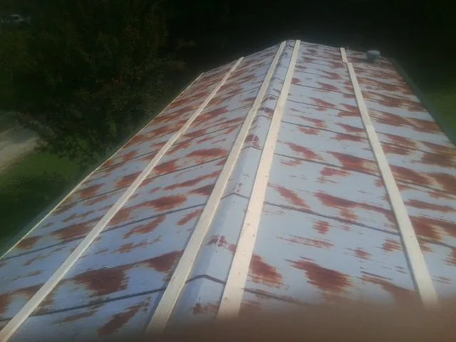 Rusted metal roof panels with new wood purlins before replacement — Storm Damage Roof Repair in Sunman by Roofing Brothers