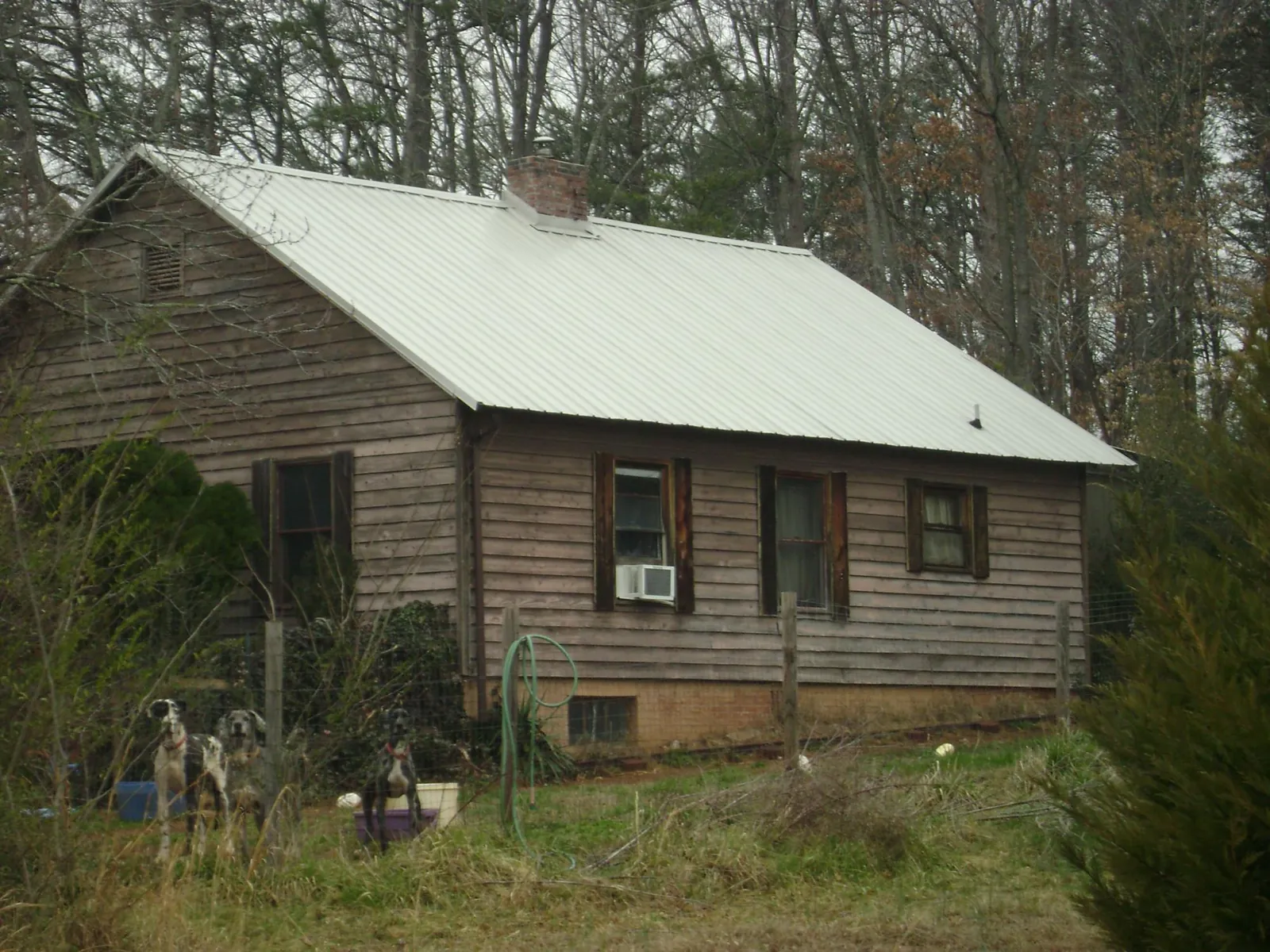White metal roof on an old wood sided farmhouse, from a Metal Roof Installation job in Sunman